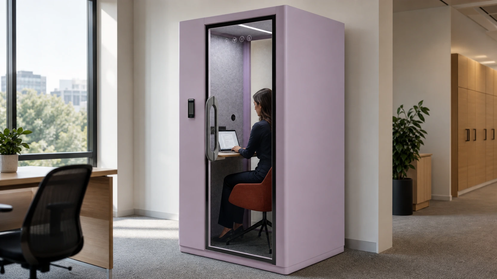A seated professional using a laptop in an exact MOVUSH solo office pod during a realistic focus task