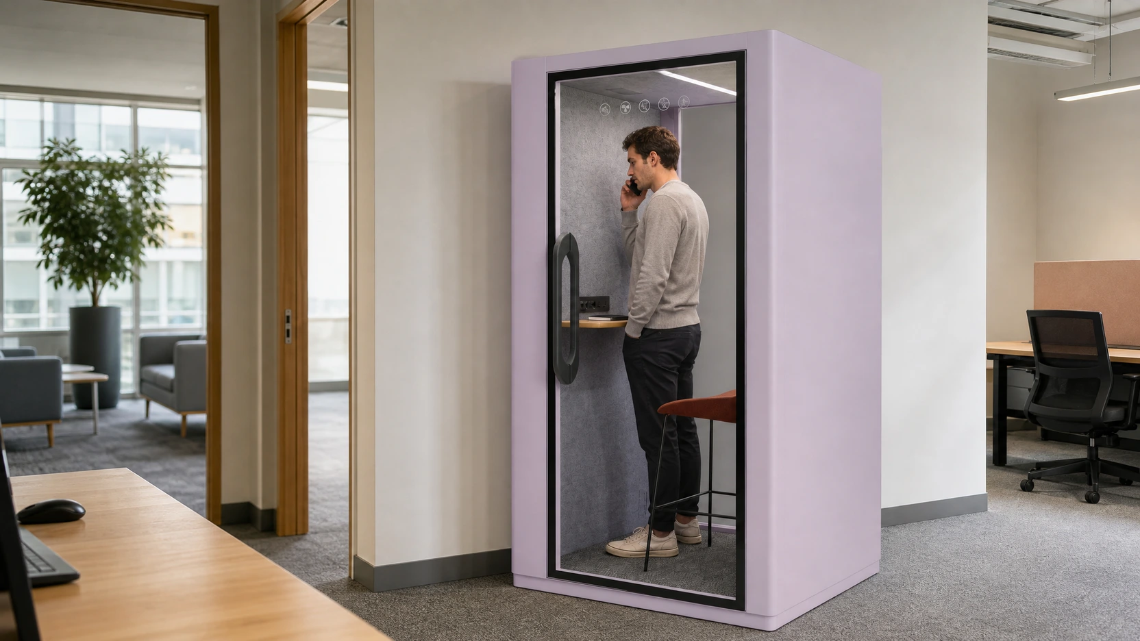 A professional completing a brief standing call inside an exact MOVUSH one-person booth